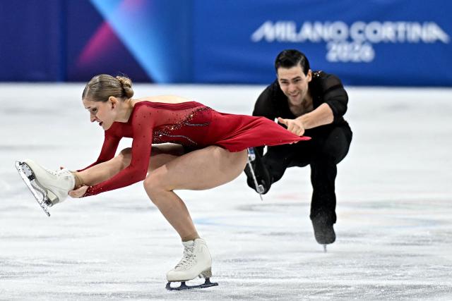 Germany's Minerva Fabienne Hase and Germany's Nikita Volodin compete in the figure skating pair skating short program during the Milano Cortina 2026 Winter Olympic Games at Milano Ice Skating Arena in Milan on February 15, 2026. (Photo by Gabriel BOUYS / AFP)
