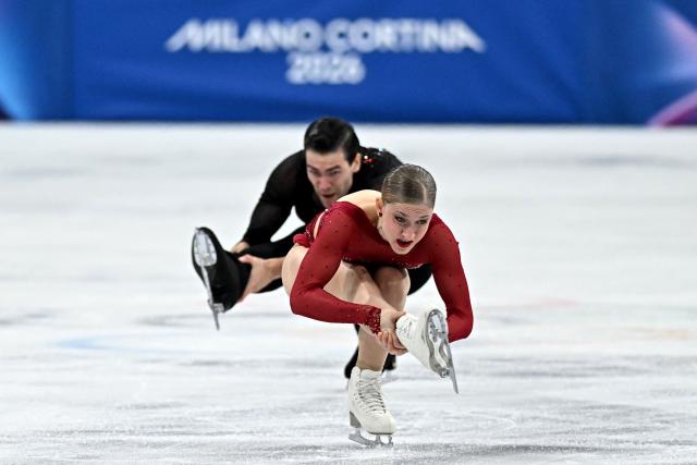 Germany's Minerva Fabienne Hase and Germany's Nikita Volodin compete in the figure skating pair skating short program during the Milano Cortina 2026 Winter Olympic Games at Milano Ice Skating Arena in Milan on February 15, 2026. (Photo by Gabriel BOUYS / AFP)