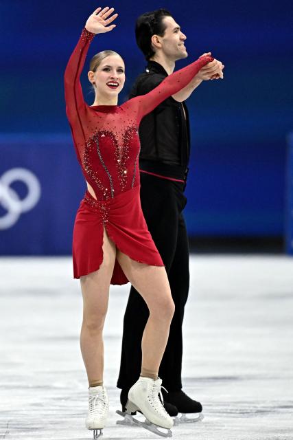 Germany's Minerva Fabienne Hase and Germany's Nikita Volodin waves after competing in the figure skating pair skating short program during the Milano Cortina 2026 Winter Olympic Games at Milano Ice Skating Arena in Milan on February 15, 2026. (Photo by Gabriel BOUYS / AFP)