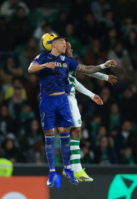 FC Famalicão's Brazilian forward #07 Marcos Vinicios and Sporting Lisbon's Mozambican forward #10 Geny Catamo vie for a header during the Portuguese league football match between Sporting CP and FC Famalicao at Jose Alvalade stadium in Lisbon on February 15, 2026. (Photo by PATRICIA DE MELO MOREIRA / AFP)
