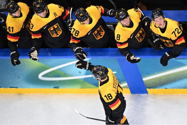 Germany's #18 Tim Stutzle celebrates scoring his team's first goal during the men's preliminary round Group C Ice Hockey match between USA and Germany at the Milano Santagiulia Ice Hockey Arena during the Milano Cortina 2026 Winter Olympic Games in Milan, on February 15, 2026. (Photo by Alexander NEMENOV / AFP)