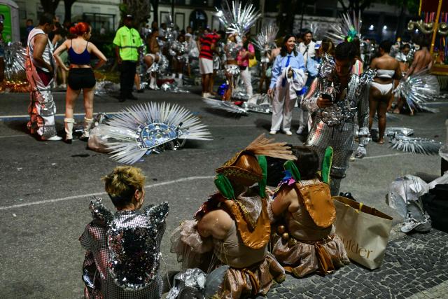 Revellers of the Academicos de Niteroi samba school prepare before the opening night of the Rio Carnival at the Marques de Sapucai Sambadrome in Rio de Janeiro, Brazil, on February 15, 2026. (Photo by Pablo PORCIUNCULA / AFP)