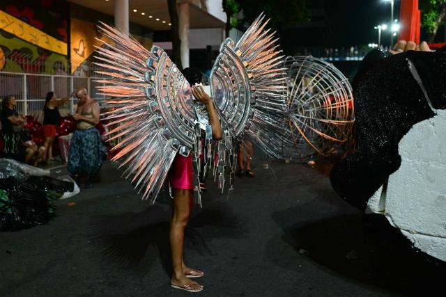 Revellers of the Academicos de Niteroi samba school prepare before the opening night of the Rio Carnival at the Marques de Sapucai Sambadrome in Rio de Janeiro, Brazil, on February 15, 2026. (Photo by Pablo PORCIUNCULA / AFP)