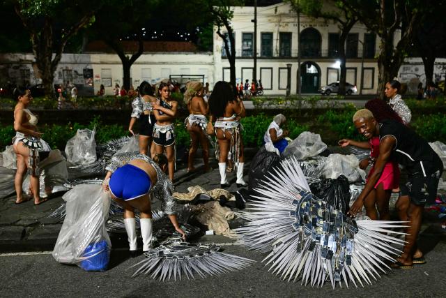 Revellers of the Academicos de Niteroi samba school prepare before the opening night of the Rio Carnival at the Marques de Sapucai Sambadrome in Rio de Janeiro, Brazil, on February 15, 2026. (Photo by Pablo PORCIUNCULA / AFP)