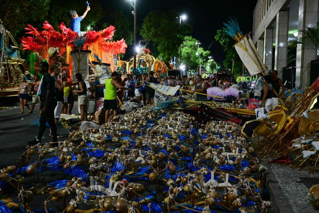 Revellers of the Academicos de Niteroi samba school prepare before the opening night of the Rio Carnival at the Marques de Sapucai Sambadrome in Rio de Janeiro, Brazil, on February 15, 2026. (Photo by Pablo PORCIUNCULA / AFP)