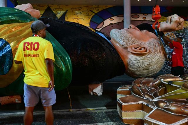 A float depicting Brazil's president Luiz Inacio Lula da Silva of the Academicos de Niteroi samba school is seen before the opening night of the Rio Carnival at the Marques de Sapucai Sambadrome in Rio de Janeiro, Brazil, on February 15, 2026. (Photo by Pablo PORCIUNCULA / AFP)