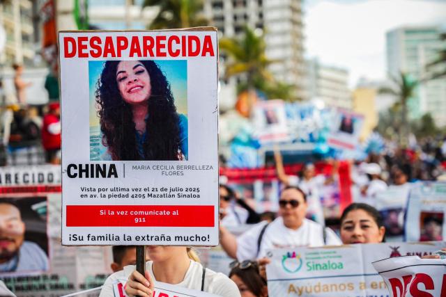 A portrait of a missing person is seen while members of a group of "searching mothers" march during the parade of International Carnival in Mazatlan, Sinaloa State, Mexico, on February 15, 2026. (Photo by Jesus Verdugo / AFP)