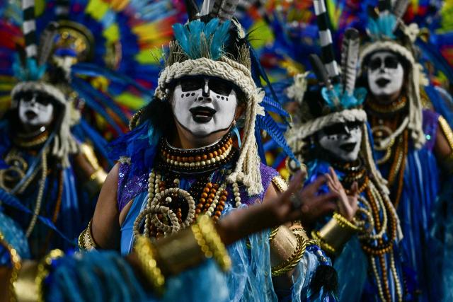 Revellers of the Imperatriz Leopoldinense samba school perform during the opening night of the Rio Carnival at the Marques de Sapucai Sambadrome in Rio de Janeiro, Brazil, on February 16, 2026. (Photo by Pablo PORCIUNCULA / AFP)