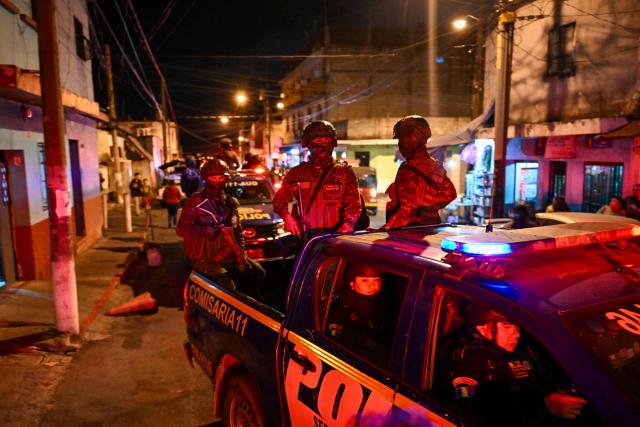 (FILES) Guatemalan Army soldiers and police officers patrol a street of the Gallito neighborhood during the state of emergency declared by the government in Guatemala City on January 22, 2026. Guatemalan President Bernardo Arevalo said on February 15, 2026, that the state of emergency he declared a month ago, which ends on February 16, had helped to control the gangs that killed eleven police officers in January and rioted in prisons. (Photo by JOHAN ORDONEZ / AFP)