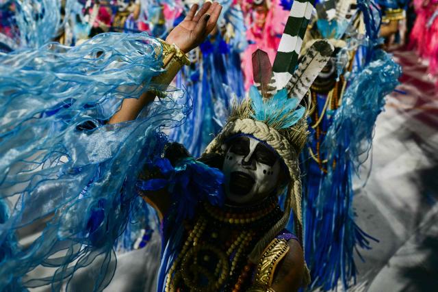 A reveller of the Imperatriz Leopoldinense samba school performs during the opening night of the Rio Carnival at the Marques de Sapucai Sambadrome in Rio de Janeiro, Brazil, on February 16, 2026. (Photo by Pablo PORCIUNCULA / AFP)