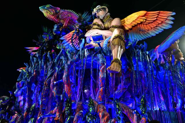 Revellers of the Imperatriz Leopoldinense samba school perform during the opening night of the Rio Carnival at the Marques de Sapucai Sambadrome in Rio de Janeiro, Brazil, on February 16, 2026. (Photo by Pablo PORCIUNCULA / AFP)