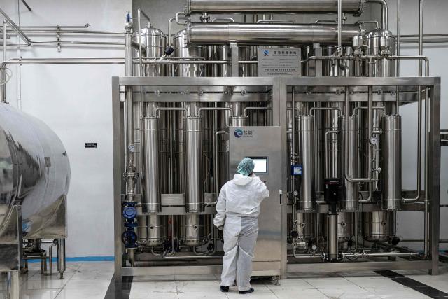 This photograph taken on February 3, 2026 shows a Pakistani technician working on water distillator at the Milli Shifa Pharmaceutical (MSP) factory on the outskirts of Kabul. Afghanistan already produces a variety of serums including antibiotics, according to manufacturer Milli Shifa Pharmaceutical. The company makes 100,000 bottles daily and "can double the capability" if demand merits, CEO Nasar Ahmad Taraki told AFP. (Photo by Wakil KOHSAR / AFP)