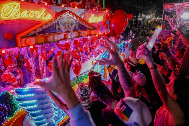 Krewe of Bacchus rolls down St. Charles Avenue during Mardi Gras festivities in New Orleans, Louisiana, on February 15, 2026. (Photo by Sandy HUFFAKER / AFP)