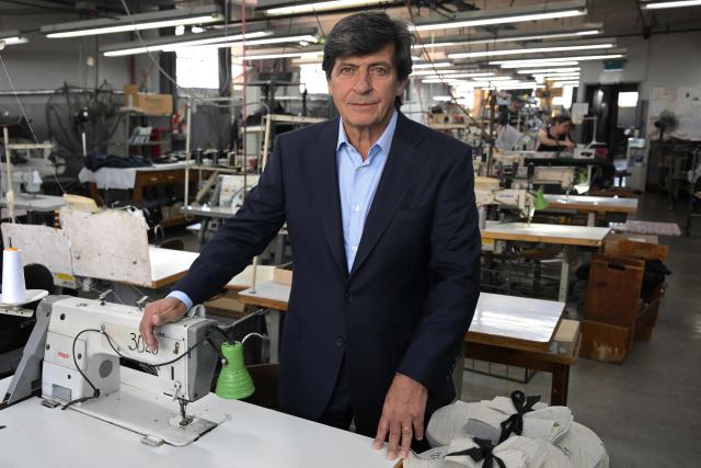 Argentine textile businessman Alejandro Pernas owner of "Confecciones Seman S.A." poses at his formal wear factory in Buenos Aires on February 10, 2026. The textile industry in Argentina is going through a crisis with falling sales, rising local production costs, and concerns about competition from imports. Since 2023, the textile sector has laid off more than 18,000 people and is operating at one-third of its installed capacity, according to February data from the consulting firm Analytica and the Argentine Textile Industries Federation (FITA). (Photo by JUAN MABROMATA / AFP)