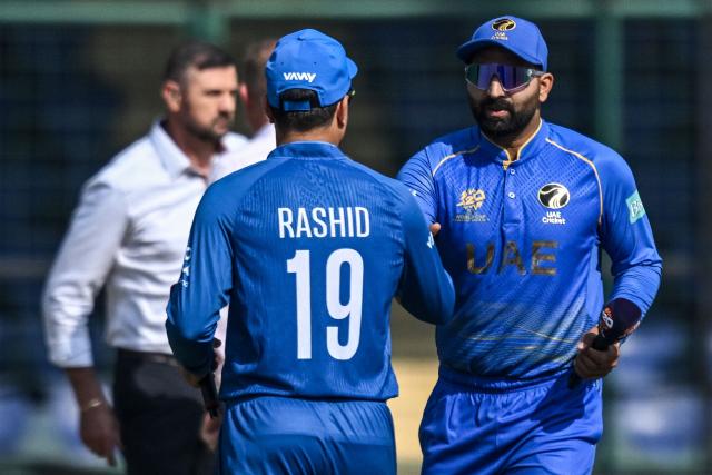 UAE's captain Muhammad Waseem (R) shakes hands with his Afghanistan counterpart Rashid Khan during the toss before the start of the 2026 ICC Men's T20 Cricket World Cup group stage match between Afghanistan and United Arab Emirates at the Arun Jaitley Stadium in New Delhi on February 16, 2026. (Photo by Arun SANKAR / AFP)