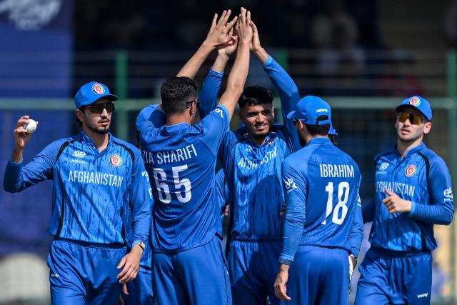 Afghanistan's Mujeeb Ur Rahman (C) celebrates with teammates after taking the wicket of UAE's captain Muhammad Waseem during the 2026 ICC Men's T20 Cricket World Cup group stage match between Afghanistan and United Arab Emirates at the Arun Jaitley Stadium in New Delhi on February 16, 2026. (Photo by Arun SANKAR / AFP)