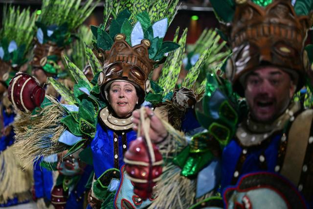 Revellers of the Portela samba school perform during the opening night of the Rio Carnival at the Marques de Sapucai Sambadrome in Rio de Janeiro, Brazil, on February 16, 2026. (Photo by Pablo PORCIUNCULA / AFP)