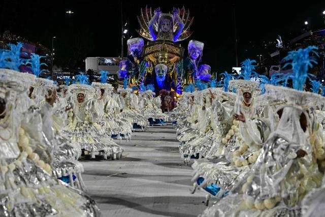 Revellers of the Portela samba school perform during the opening night of the Rio Carnival at the Marques de Sapucai Sambadrome in Rio de Janeiro, Brazil, on February 16, 2026. (Photo by Pablo PORCIUNCULA / AFP)
