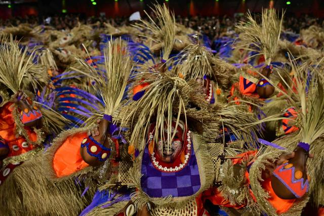 Revellers of the Portela samba school perform during the opening night of the Rio Carnival at the Marques de Sapucai Sambadrome in Rio de Janeiro, Brazil, on February 16, 2026. (Photo by Pablo PORCIUNCULA / AFP)