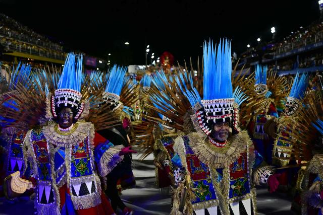 Revellers of the Portela samba school perform during the opening night of the Rio Carnival at the Marques de Sapucai Sambadrome in Rio de Janeiro, Brazil, on February 16, 2026. (Photo by Pablo PORCIUNCULA / AFP)