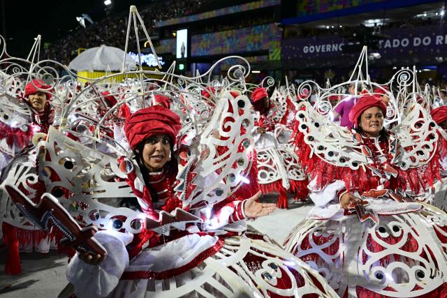 Revellers of the Portela samba school perform during the opening night of the Rio Carnival at the Marques de Sapucai Sambadrome in Rio de Janeiro, Brazil, on February 16, 2026. (Photo by Pablo PORCIUNCULA / AFP)
