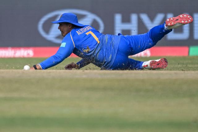 UAE's Alishan Sharafu dives to field the ball during the 2026 ICC Men's T20 Cricket World Cup group stage match between Afghanistan and United Arab Emirates at the Arun Jaitley Stadium in New Delhi on February 16, 2026. (Photo by Arun SANKAR / AFP)