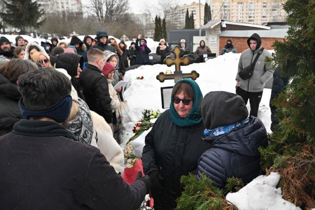 Lyudmila Navalnaya (?), mother of late Russian opposition leader Alexei Navalny, visits her son's grave at the Borisovo cemetery in Moscow on February 16, 2026, marking the second anniversary of his death in an Arctic colony. (Photo by Hector RETAMAL / AFP) / NAVALNY HAS BEEN DECLARED "EXTREMIST" BY RUSSIAN AUTHORITIES. IN RUSSIA, ANYBODY WHO MENTIONS NAVALNY OR HIS ANTI-CORRUPTION FOUNDATION WITHOUT STATING THAT THEY HAVE BEEN DECLARED "EXTREMIST" IS SUBJECT TO FINES OR UP TO FOUR YEARS IN PRISON FOR REPEATED OFFENCES. / 