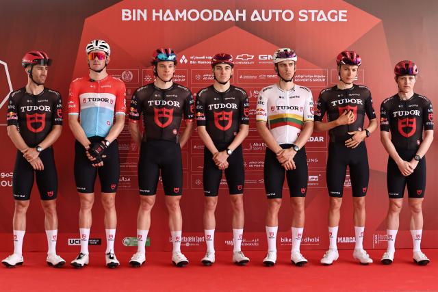 Team Tudor Pro Cycling's riders pose on the stage ahead of the first stage of the UAE Tour cycling event from Madinat Zayed Majlis to Liwa Palace in Abu Dhabi on February 16, 2026. (Photo by Fadel SENNA / AFP)