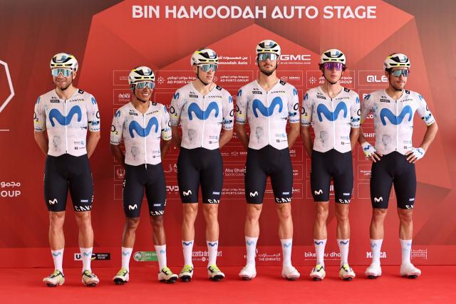 Team Movistar's riders pose on the stage ahead of the first stage of the UAE Tour cycling event from Madinat Zayed Majlis to Liwa Palace in Abu Dhabi on February 16, 2026. (Photo by Fadel SENNA / AFP)