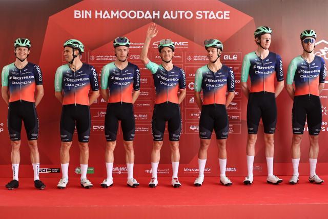Team Decathlon CMA CGM's riders pose on the stage ahead of the first stage of the UAE Tour cycling event from Madinat Zayed Majlis to Liwa Palace in Abu Dhabi on February 16, 2026. (Photo by Fadel SENNA / AFP)