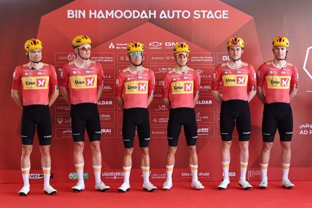 Team Uno-X Mobility's riders pose on the stage ahead of the first stage of the UAE Tour cycling event from Madinat Zayed Majlis to Liwa Palace in Abu Dhabi on February 16, 2026. (Photo by Fadel SENNA / AFP)