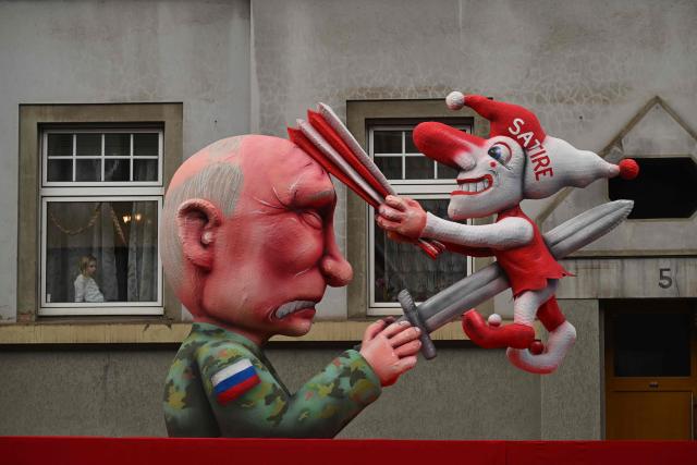 A carnival float designed by German carnival float builder Jacques Tilly featuring Russian President Vladimir Putin is pictured during the parade to celebrate Rose Monday (Rosenmontag), on February 16, 2026 in Duesseldorf, western Germany. (Photo by INA FASSBENDER / AFP)