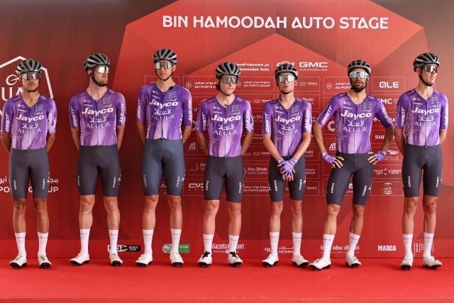 Team Jayco Alula's riders pose on the stage ahead of the first stage of the UAE Tour cycling event from Madinat Zayed Majlis to Liwa Palace in Abu Dhabi on February 16, 2026. (Photo by Fadel SENNA / AFP)