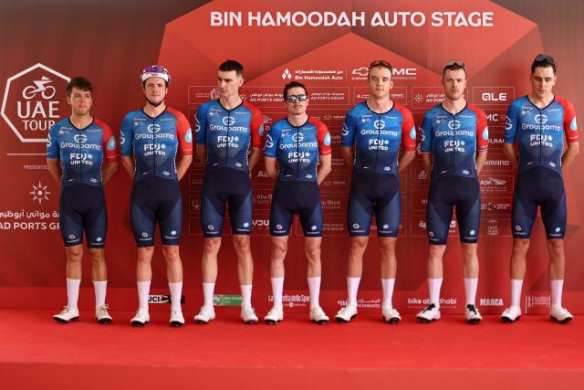 Team Groupama-FDJ United's riders pose on the stage ahead of the first stage of the UAE Tour cycling event from Madinat Zayed Majlis to Liwa Palace in Abu Dhabi on February 16, 2026. (Photo by Fadel SENNA / AFP)