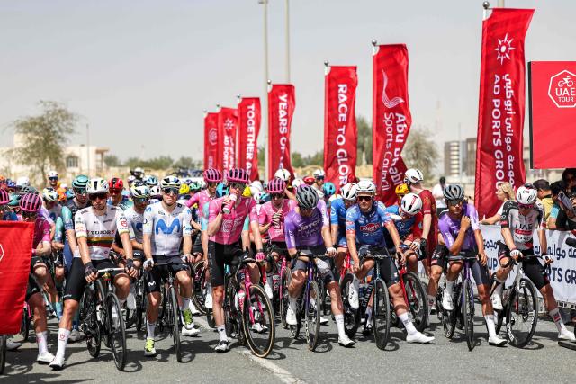 Riders wait at the start line before the first stage of the UAE Tour cycling event from Madinat Zayed Majlis to Liwa Palace in Abu Dhabi on February 16, 2026. (Photo by Fadel SENNA / AFP)