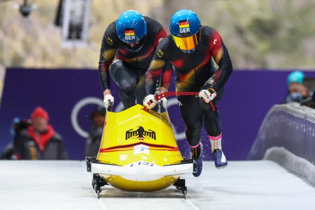 Germany's Francesco Friedrich and Germany's Alexander Schueller compete in the bobsleigh men's 2-man heat 1 at Cortina Sliding Centre during the Milano Cortina 2026 Winter Olympic Games in Cortina d'Ampezzo on February 16, 2026. (Photo by FRANCK FIFE / AFP)