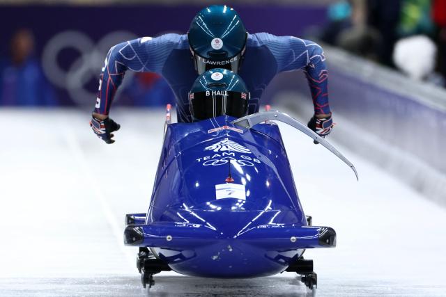 Britain's Brad Hall and Britain's Taylor Lawrence compete in the bobsleigh men's 2-man heat 1 at Cortina Sliding Centre during the Milano Cortina 2026 Winter Olympic Games in Cortina d'Ampezzo on February 16, 2026. (Photo by FRANCK FIFE / AFP)