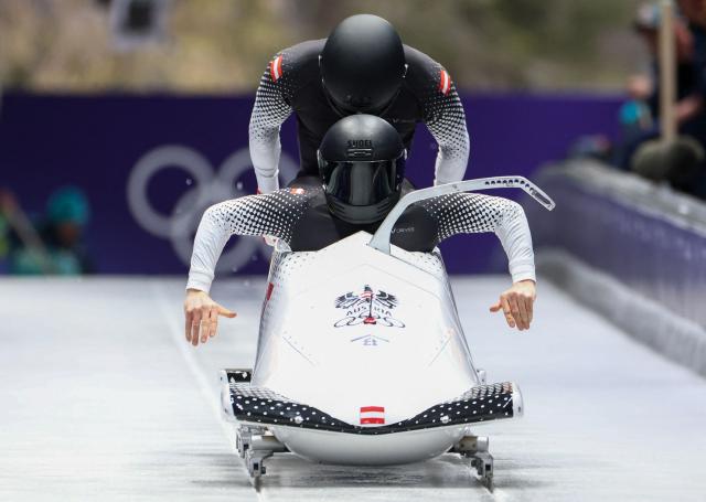 Austria's Markus Treichl and Austria's Daniel Bertschler compete in the bobsleigh men's 2-man heat 1 at Cortina Sliding Centre during the Milano Cortina 2026 Winter Olympic Games in Cortina d'Ampezzo on February 16, 2026. (Photo by FRANCK FIFE / AFP)