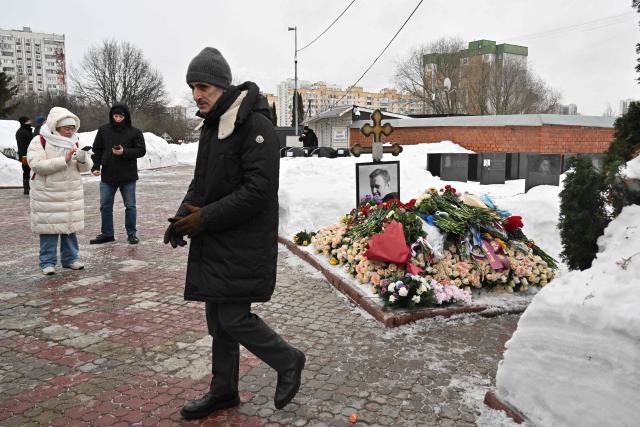 French embassy official Thomas Zacharie Gross-Huguet visits the grave of Russian opposition leader Alexei Navalny at the Borisovo cemetery in Moscow on February 16, 2026, marking the second anniversary of his death in an Arctic colony. (Photo by Hector RETAMAL / AFP) / NAVALNY HAS BEEN DECLARED "EXTREMIST" BY RUSSIAN AUTHORITIES. IN RUSSIA, ANYBODY WHO MENTIONS NAVALNY OR HIS ANTI-CORRUPTION FOUNDATION WITHOUT STATING THAT THEY HAVE BEEN DECLARED "EXTREMIST" IS SUBJECT TO FINES OR UP TO FOUR YEARS IN PRISON FOR REPEATED OFFENCES. / 