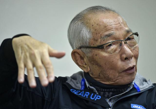 (FILES) King Liu, chairman of the world's biggest bicycle maker Giant, gestures during an interview with AFP in central Taichung on February 23, 2016. King Liu, the founder of Taiwanese bicycle maker Giant and a self-described "missionary" for cycling culture, died on February 16, 2026 at the age of 93, the company said. (Photo by SAM YEH / AFP)