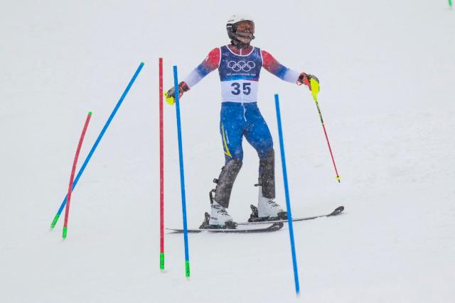 South Korea's Jung Dong-hyun skis out in the first run of the men's slalom alpine skiing event during the Milano Cortina 2026 Winter Olympic Games at the Stelvio Ski Centre in Bormio (Valtellina) on February 16, 2026. (Photo by Dimitar DILKOFF / AFP)