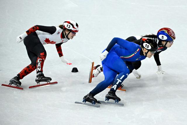 Canada's Kim Boutin, Italy's Arianna Fontana and South Korea's Choi Min-jeong compete in the short track speed skating women's 1000m quarter-final during the Milano Cortina 2026 Winter Olympic Games at Milano Ice Skating Arena in Milan on February 16, 2026. (Photo by WANG Zhao / AFP)