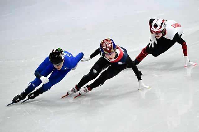 Italy's Arianna Fontana, South Korea's Choi Min-jeong and Canada's Kim Boutin competes in the short track speed skating women's 1000m quarter-final during the Milano Cortina 2026 Winter Olympic Games at Milano Ice Skating Arena in Milan on February 16, 2026. (Photo by JULIEN DE ROSA / AFP)