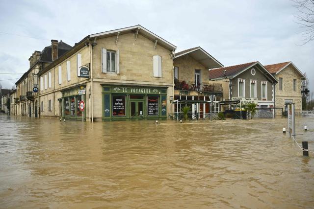 This photograph shows the city center flooded by the Garonne river in Cadillac-sur-Garonne, south-western France, on February 16, 2026. The flood alert system in France has been working at a record pace as relentless rain over the past month has saturated soils, the head of the agency told AFP on February 14, 2026. "For 30 days we have been in continuous orange or red alert somewhere on the national territory," Lucie Chadourne-Facon, director of Vigicrues, told AFP, referring to the two highest alert levels. (Photo by Gaizka IROZ / AFP)