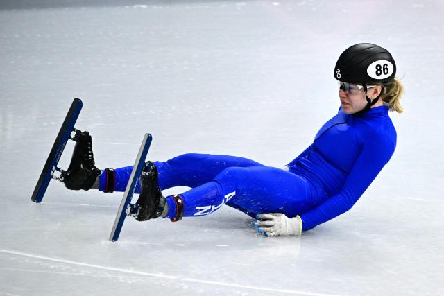 Individual Neutral Athlete Alena Krylova crashes in the short track speed skating women's 1000m quarter-final during the Milano Cortina 2026 Winter Olympic Games at Milano Ice Skating Arena in Milan on February 16, 2026. (Photo by JULIEN DE ROSA / AFP)