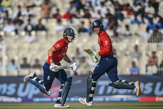 England's Jacob Bethell (L) and Tom Banton run between the wickets during the 2026 ICC Men's T20 Cricket World Cup group stage match between England and Italy at the Eden Gardens in Kolkata on February 16, 2026. (Photo by Dibyangshu SARKAR / AFP)