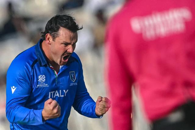 Italy's Ben Manenti celebrates after taking the wicket of England's Jacob Bethell during the 2026 ICC Men's T20 Cricket World Cup group stage match between England and Italy at the Eden Gardens in Kolkata on February 16, 2026. (Photo by Dibyangshu SARKAR / AFP)