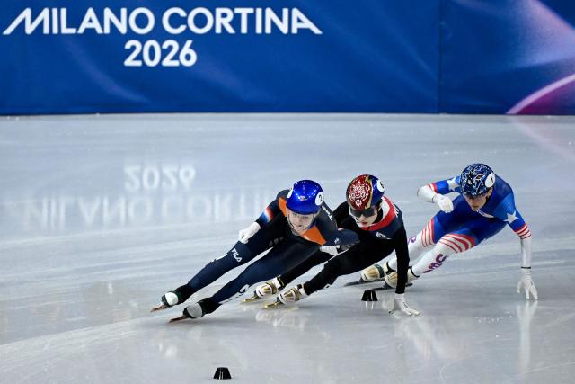 Netherlands' Xandra Velzeboer, South Korea's Kim Gil-li and USA's Kristen Santos-Griswold compete in the short track speed skating women's 1000m quarter-final during the Milano Cortina 2026 Winter Olympic Games at Milano Ice Skating Arena in Milan on February 16, 2026. (Photo by WANG Zhao / AFP)