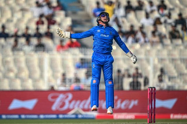 Italy's wicketkeeper Gian-Piero Meade celebrates after taking a catch to dismiss England's captain Harry Brook during the 2026 ICC Men's T20 Cricket World Cup group stage match between England and Italy at the Eden Gardens in Kolkata on February 16, 2026. (Photo by Dibyangshu SARKAR / AFP)