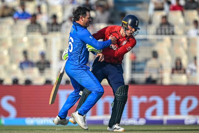 Italy's Ben Manenti (L) collides with England's Tom Banton during the 2026 ICC Men's T20 Cricket World Cup group stage match between England and Italy at the Eden Gardens in Kolkata on February 16, 2026. (Photo by Dibyangshu SARKAR / AFP)